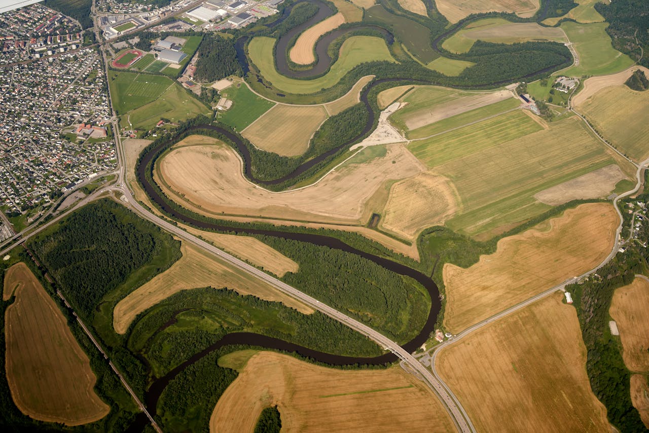 Stunning aerial view showing farmland, river bends, and nearby town.